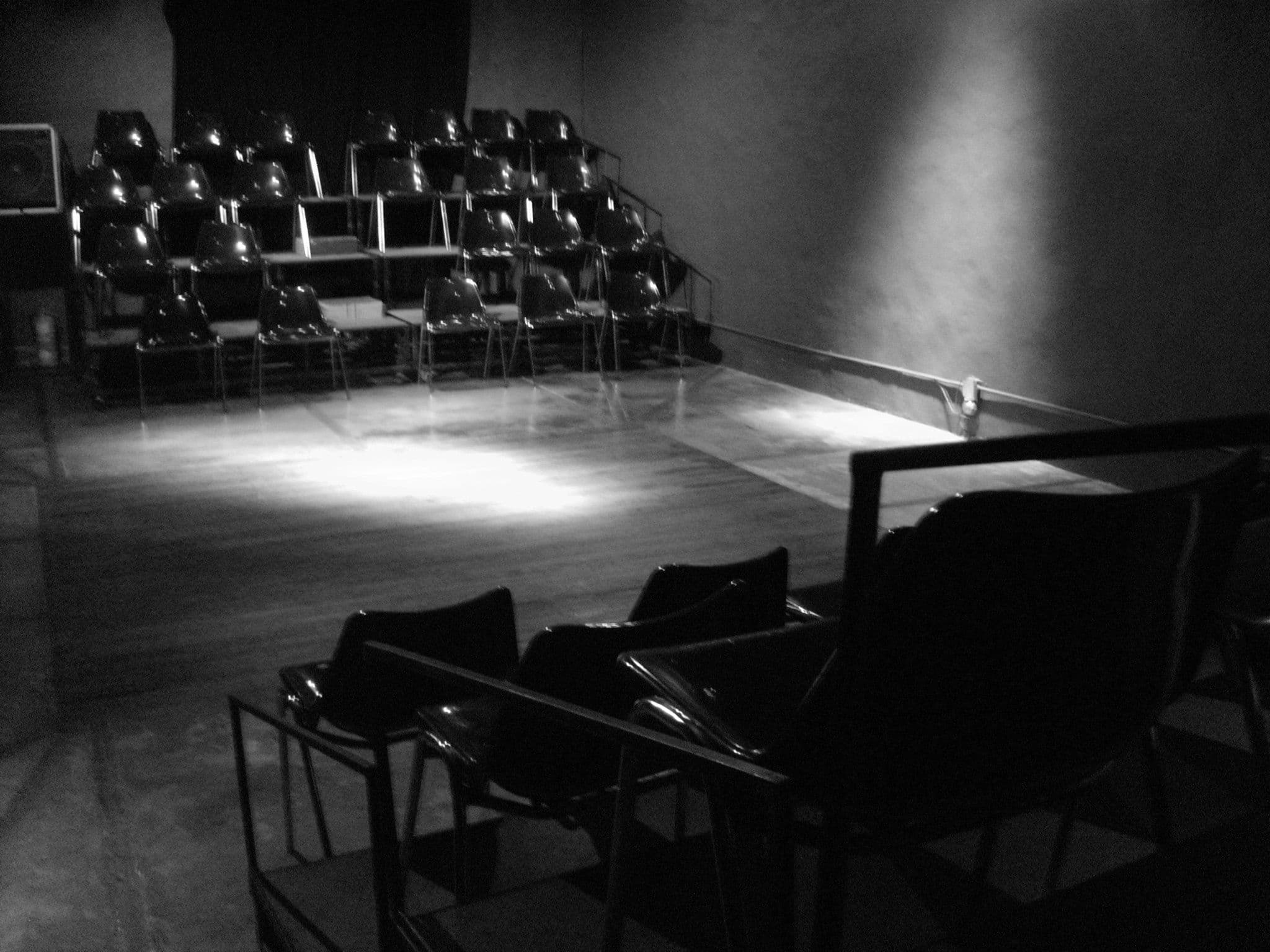 La sala vacía, con las butacas en gradas y luz sobre el escenario